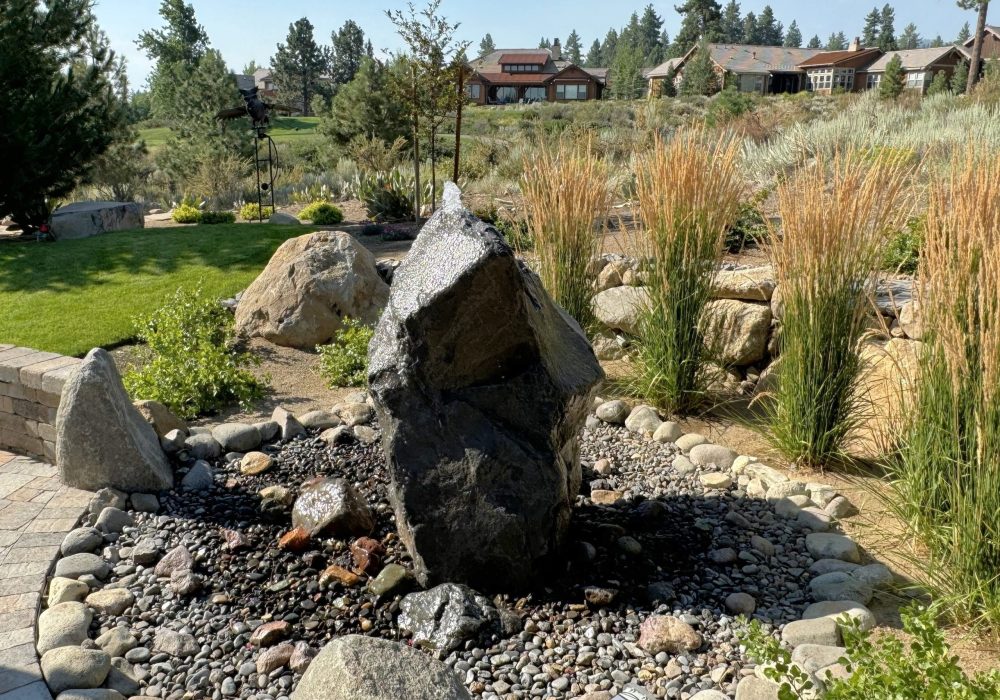 Cored boulder pond less water feature